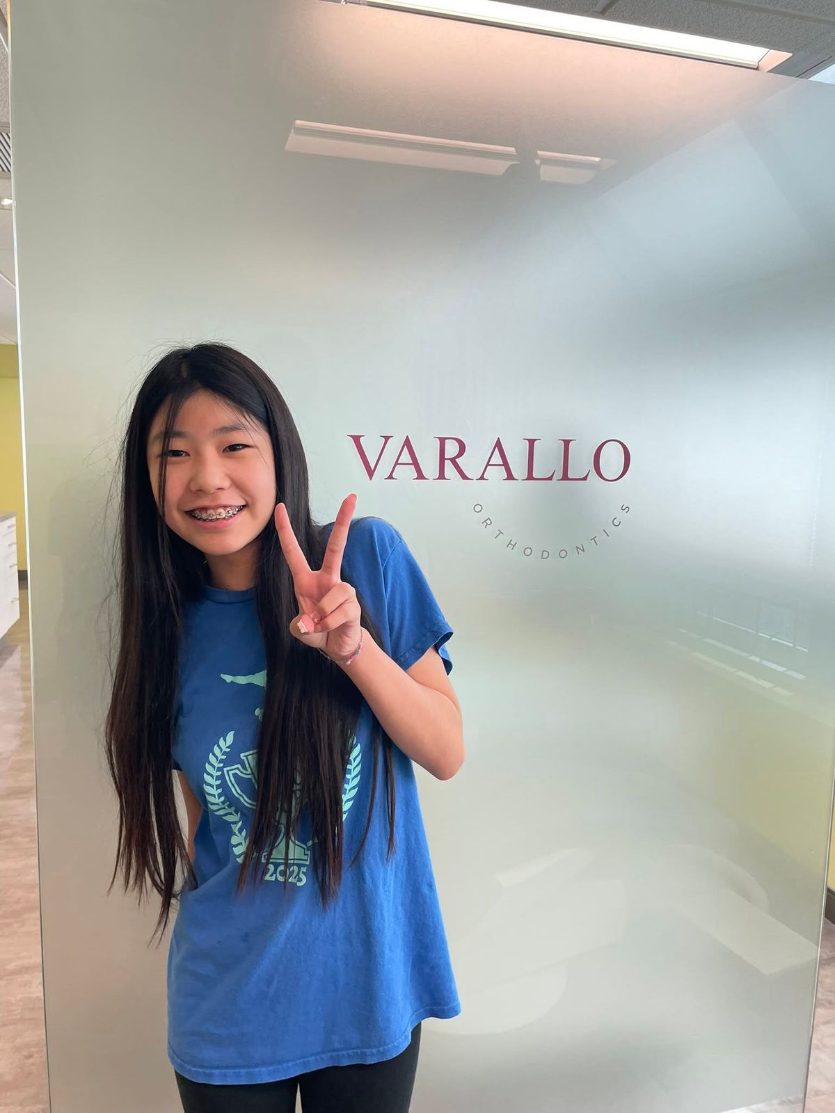 young patient in a Varallo Orthodontics shirt