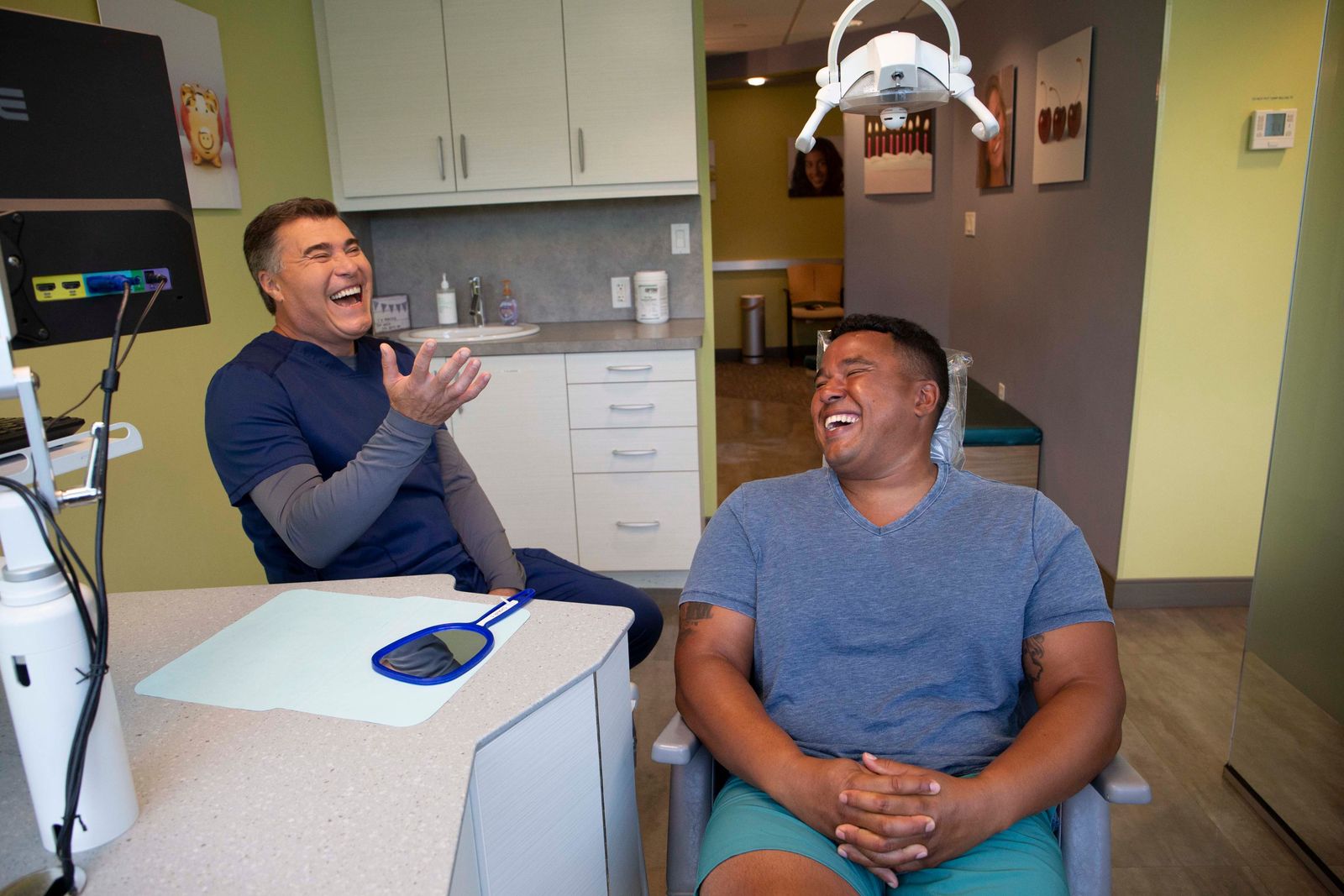 Dr. Varallo laughing with a patient in the treatment room