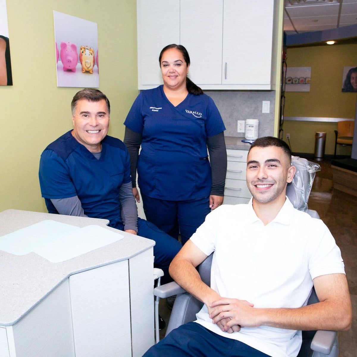 Patient with Dr. Varallo and a team member in the treatment room