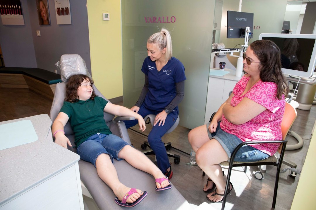 A Varallo Orthodontics team member treating a young patient